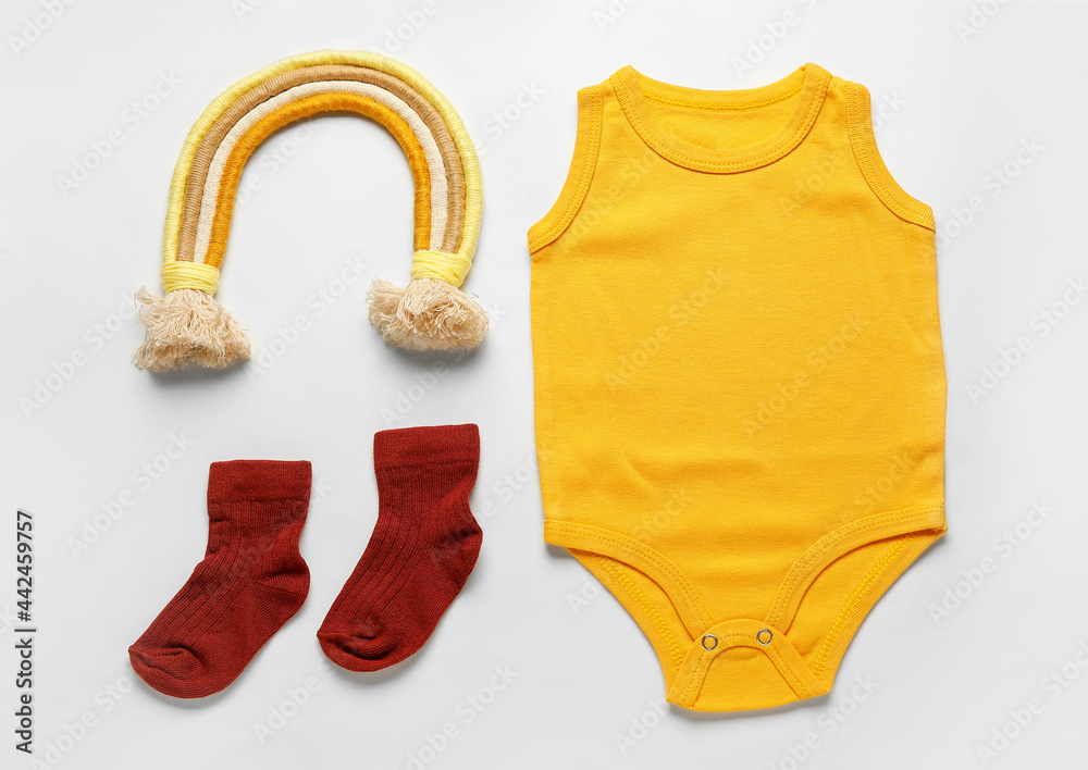 Baby clothes and socks on white background