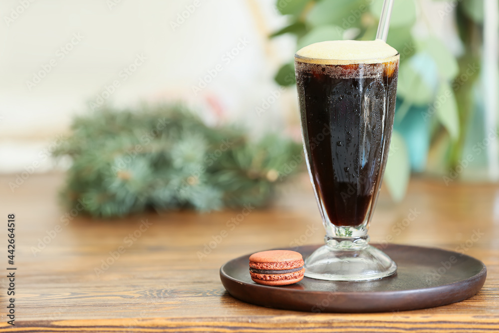 Glass of tasty iced coffee on table