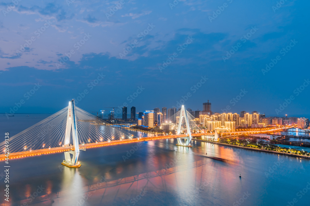 High-view night view of Haidian River Century Bridge in Haikou, Hainan, China 