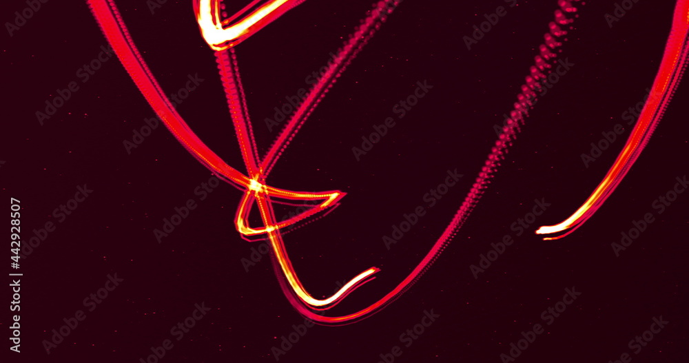 Two glowing red lines entertwining moving on a black background