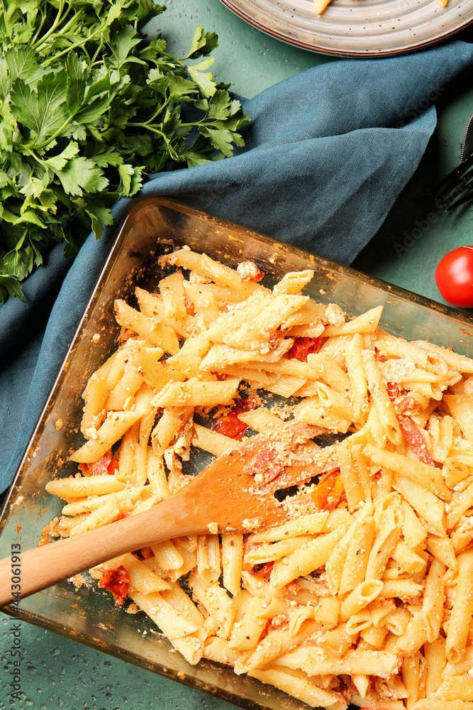 Baking dish with healthy pasta on color background