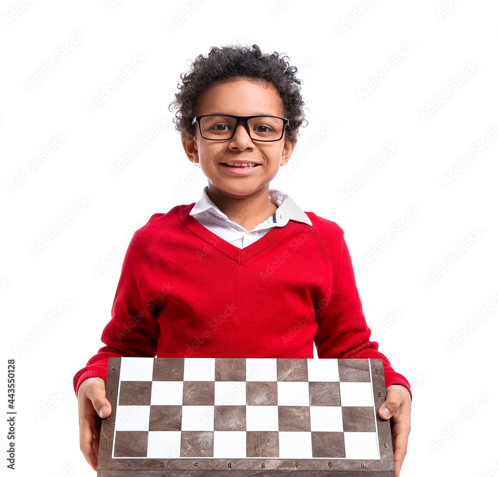 Cute African-American boy with chessboard on white background