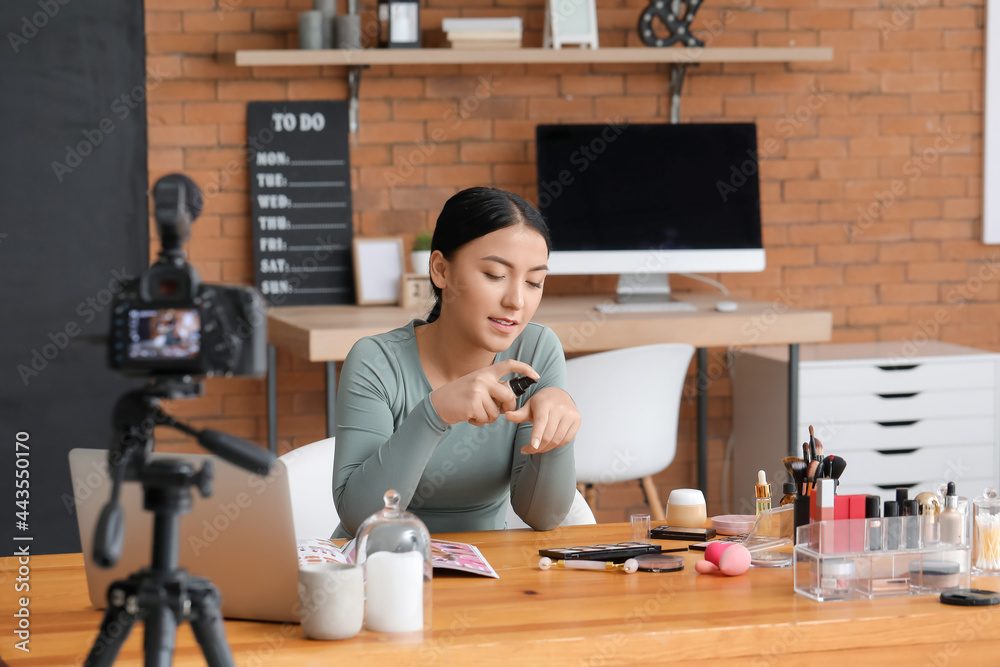 Asian beauty blogger recording video at home