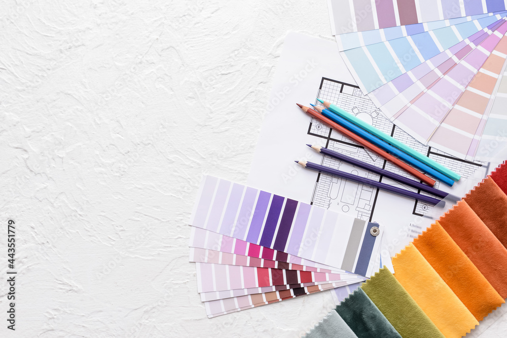 Composition with paint color palettes and fabric samples on white background