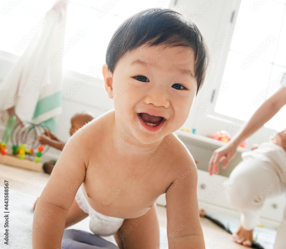 Asian baby crawling on the floor