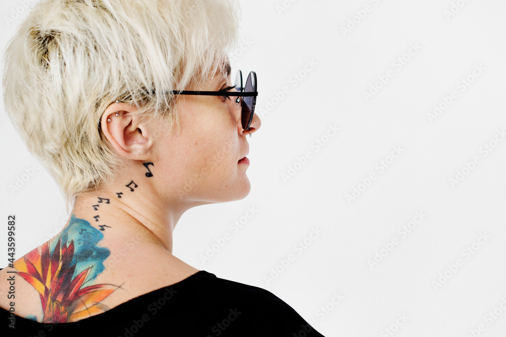 Stylish woman with a tattoo on her neck