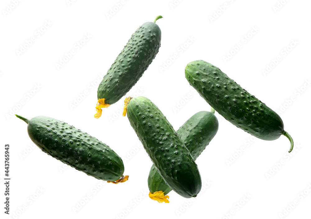 Flying cucumbers on white background