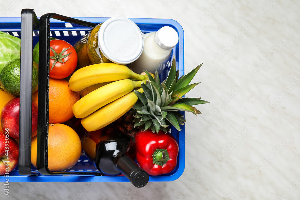 Shopping basket with food on white background