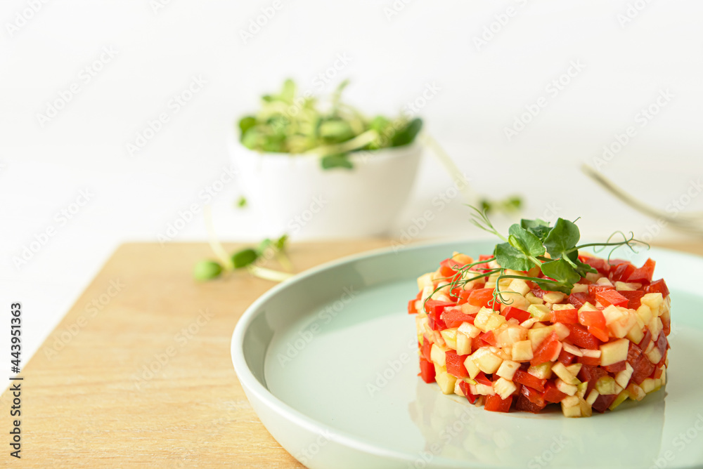 Plate with tasty tartare salad on light background, closeup