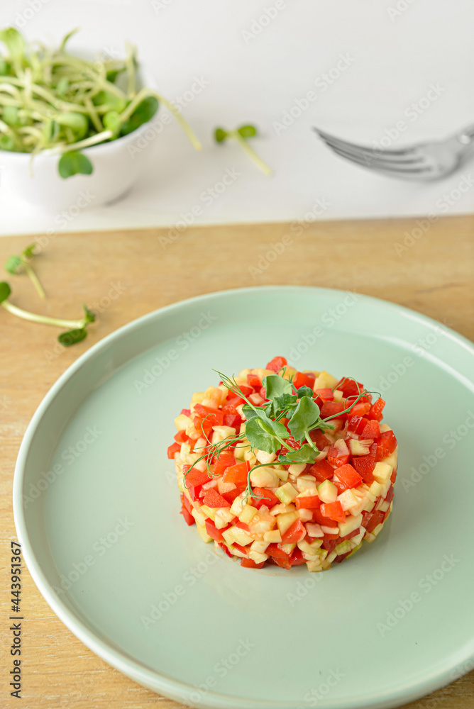 Plate with tasty tartare salad on light background