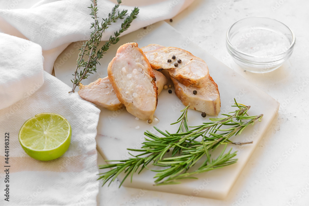 Tasty cut chicken fillet on light background