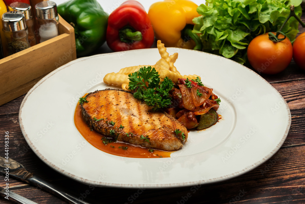 Grilled salmon with lemon and potato on wooden