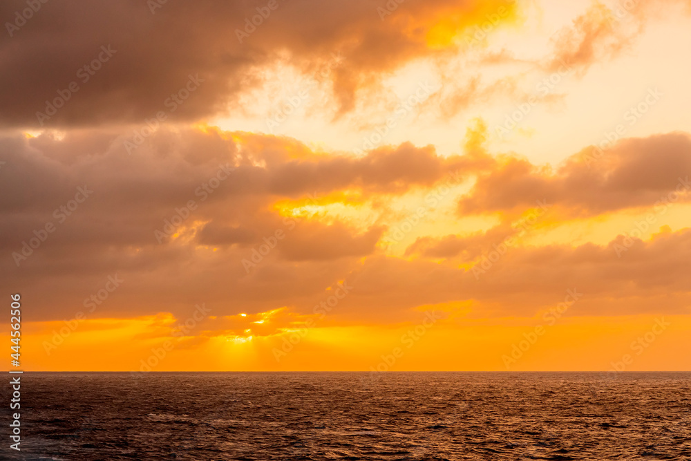 Stunning dramatic sunset or sunrise colorful sky cloud and oceas sea water wave nature background