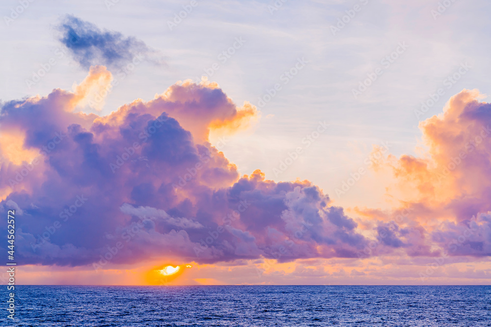 Stunning dramatic sunset or sunrise colorful sky cloud and oceas sea water wave nature background