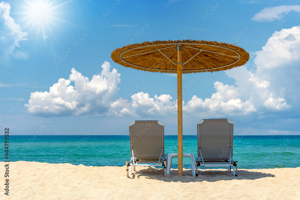 Beach chair with umbrella with blue sky and sun