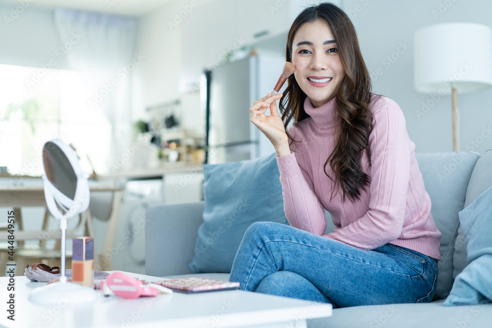 Portrait of beautiful woman artist stay home, enjoying makeup herself. 