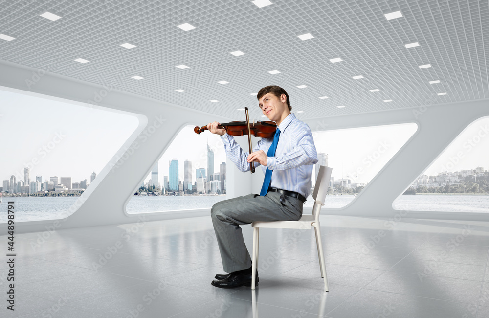 young businessman playing violin