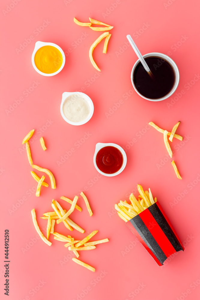 French fries in red paper wrapper with different sauces