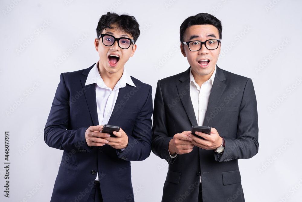 Two Asian businessmen using smartphone on white background