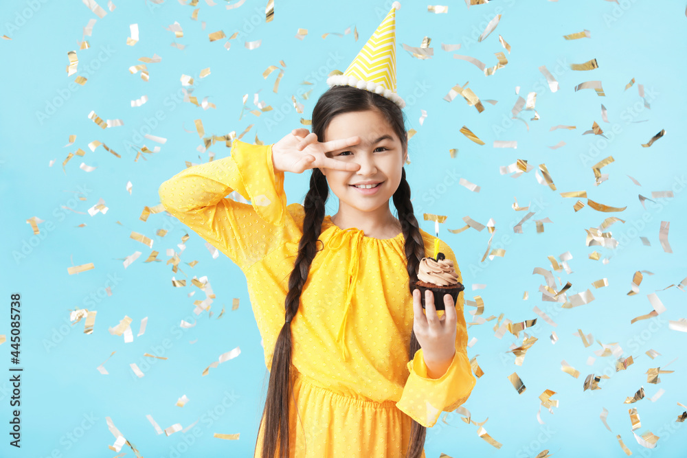 Cute little girl celebrating Birthday on color background