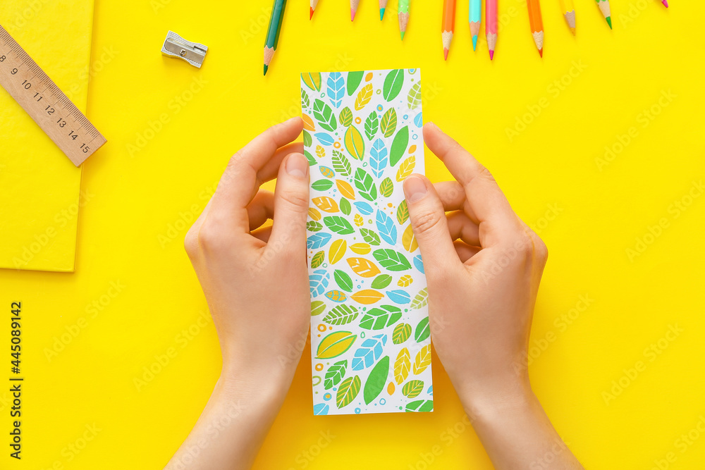 Woman with bookmark on color background