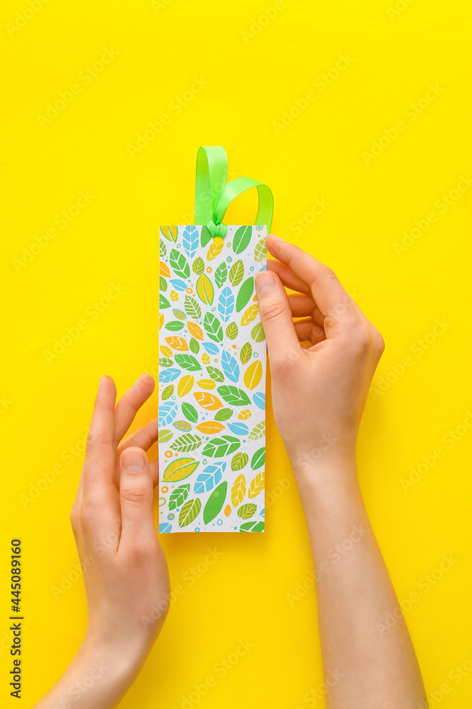 Woman with bookmark on color background