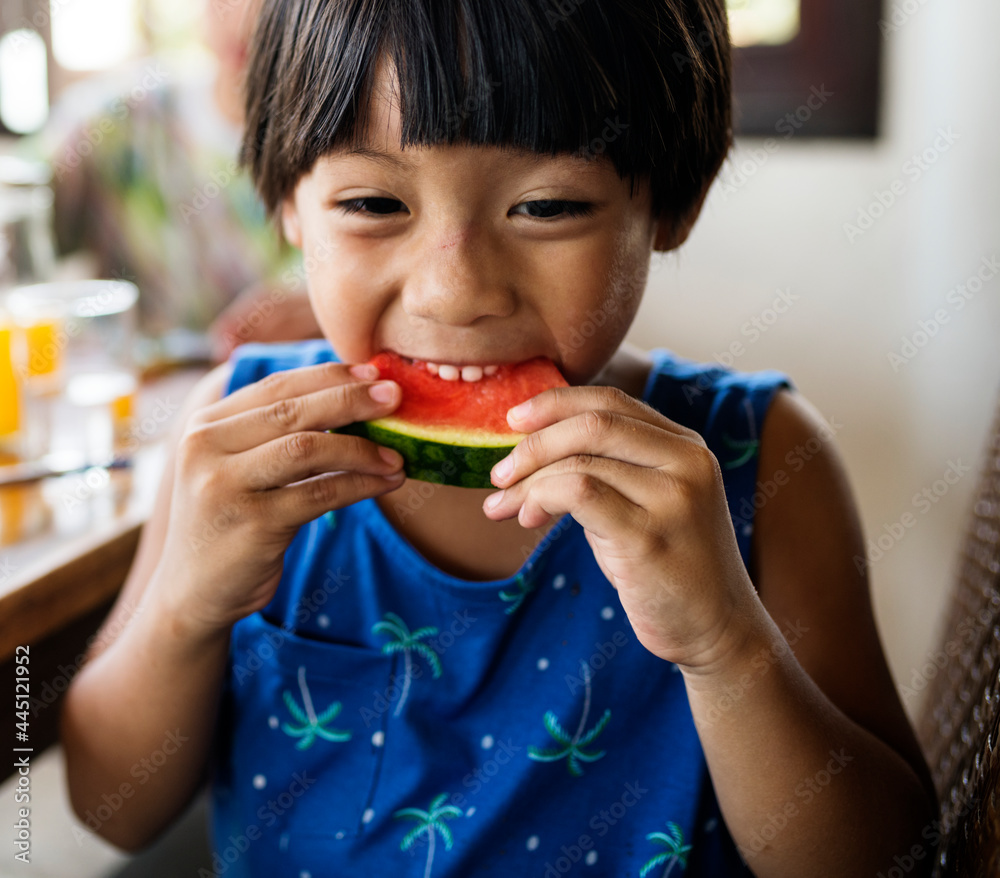 Little boy enjoying a piece of watermelon