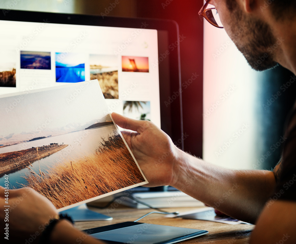 A man editing photos on a acomputer