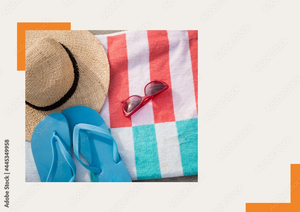 Photograph of flip flops, sunglasses and starfish against grey background