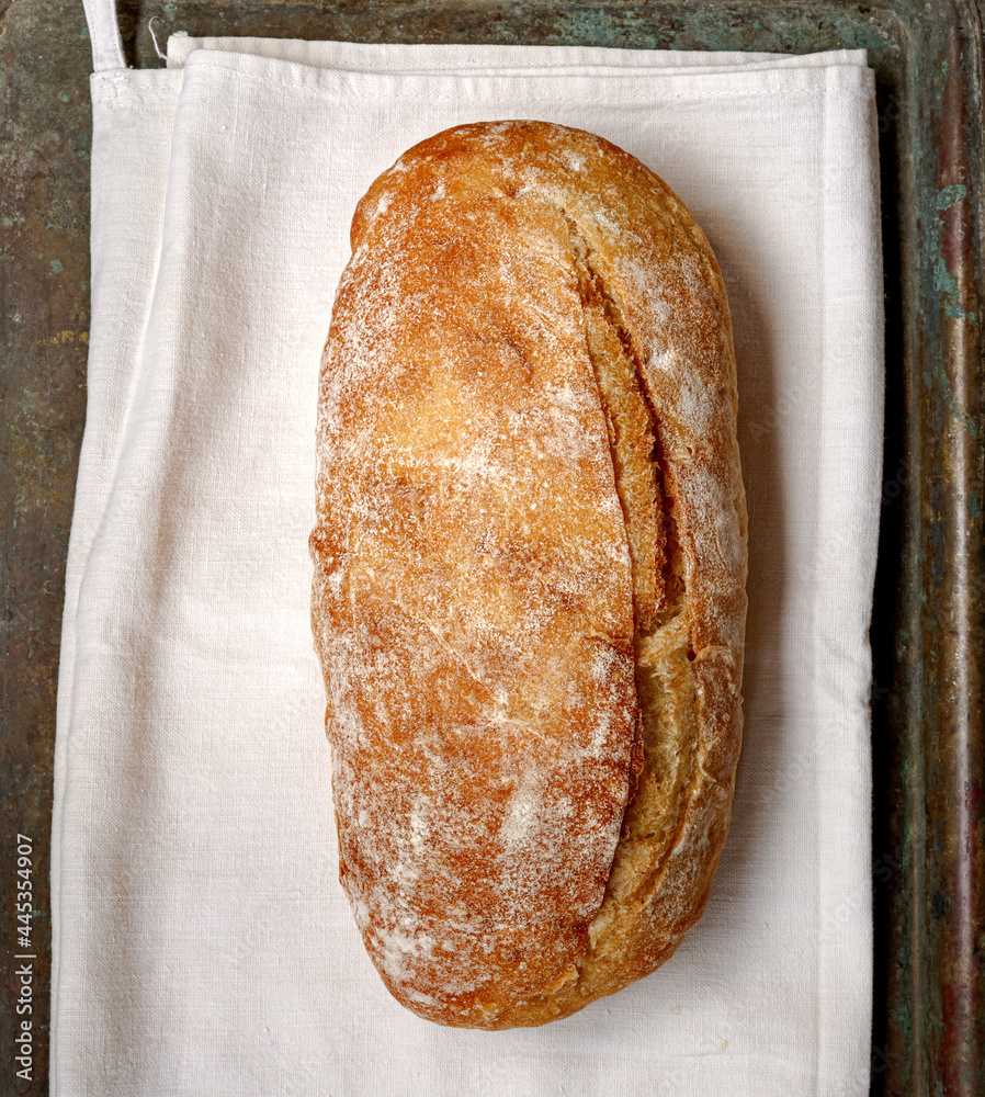 Sliced bread ciabatta on vintage linen napkin. Top view of homemade ciabatta. Flat lay.