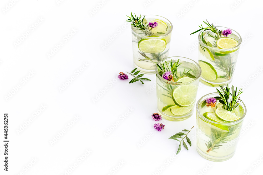 Cold fresh cocktail with summer herbs and lemon slices