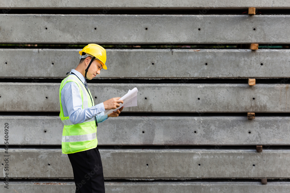 Asian engineer looking on blue printed and building structure, Worker get social security and insura