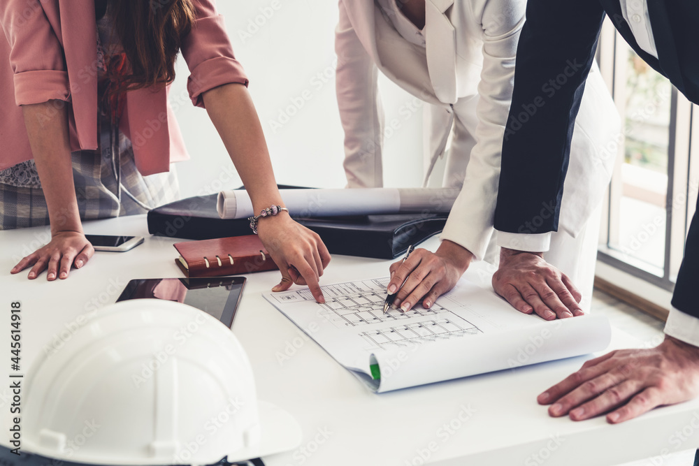 Architect and engineer working with construction drawing project on table in office. Architecture an