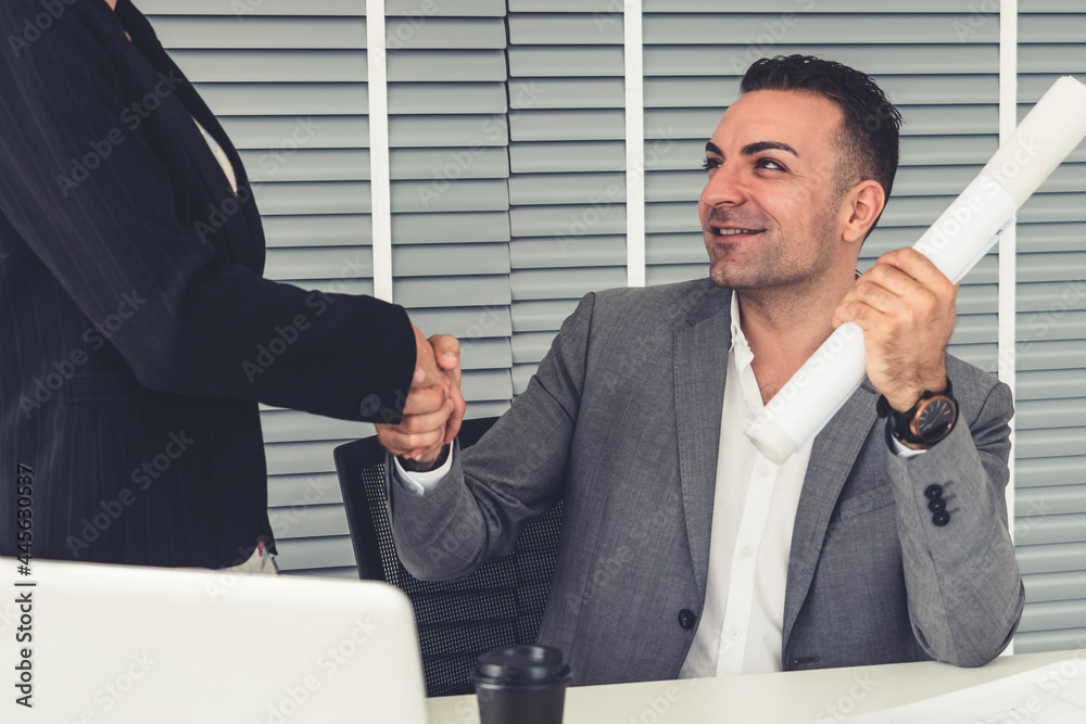 Businessman executive handshake with businesswoman worker in modern workplace office. People corpora