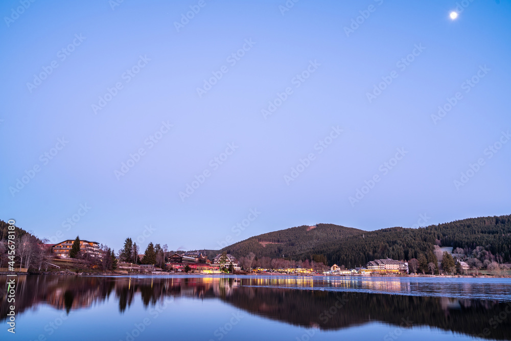 Early in the evening, the surface of Lake Großer Alpsee in Immenstadt, Bavaria, Germany under the bl