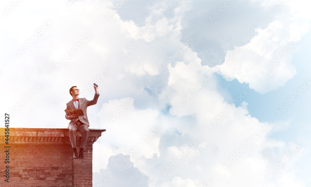 Young businessman or student studying the science on building roof