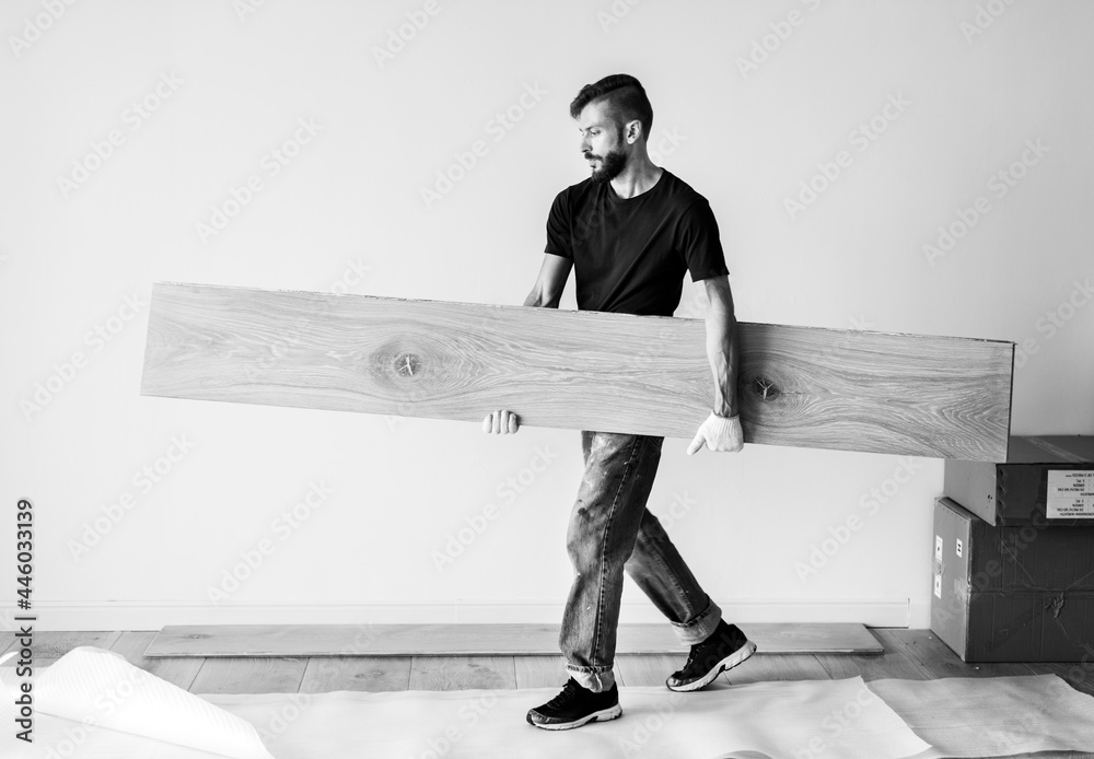 Carpenter man installing wooden floor