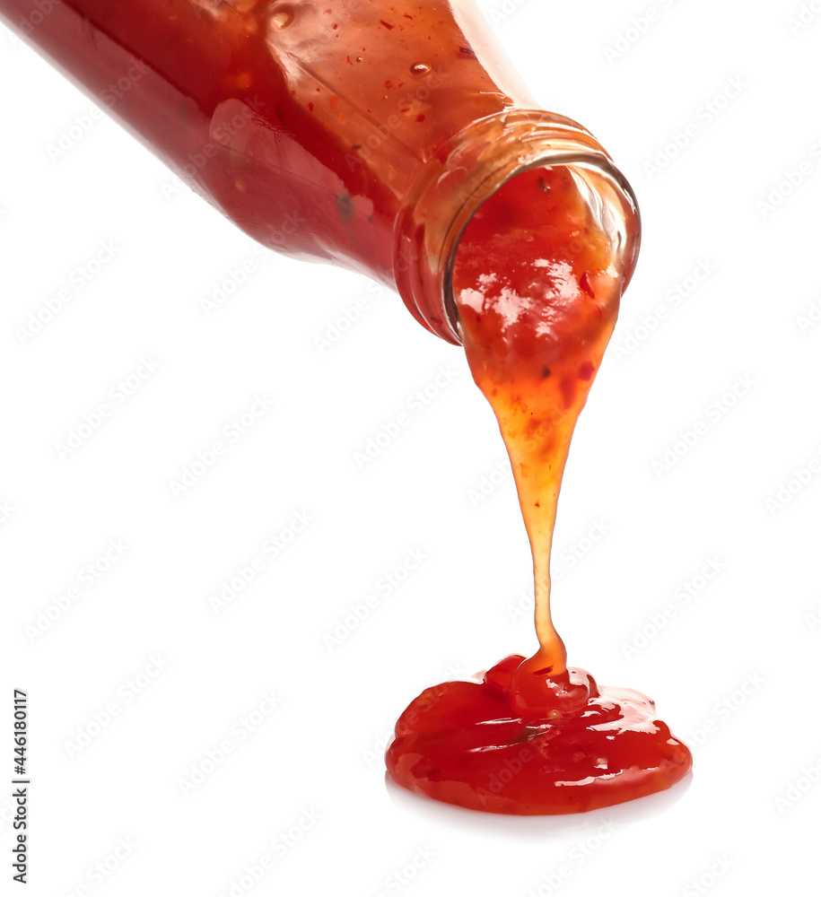 Bottle with spilled chili sauce on white background