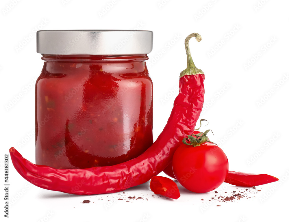 Jar of tasty salsa sauce on white background