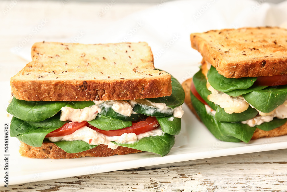 Plate with tasty sandwiches on light background, closeup