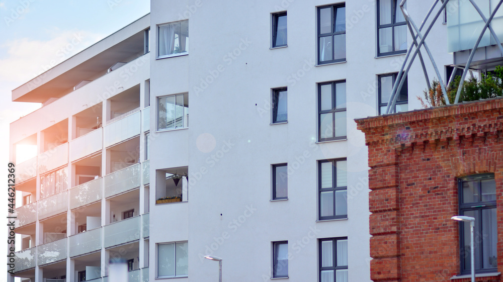 Modern apartment buildings on a sunny day with a blue sky. Facade of a modern apartment building. Gl