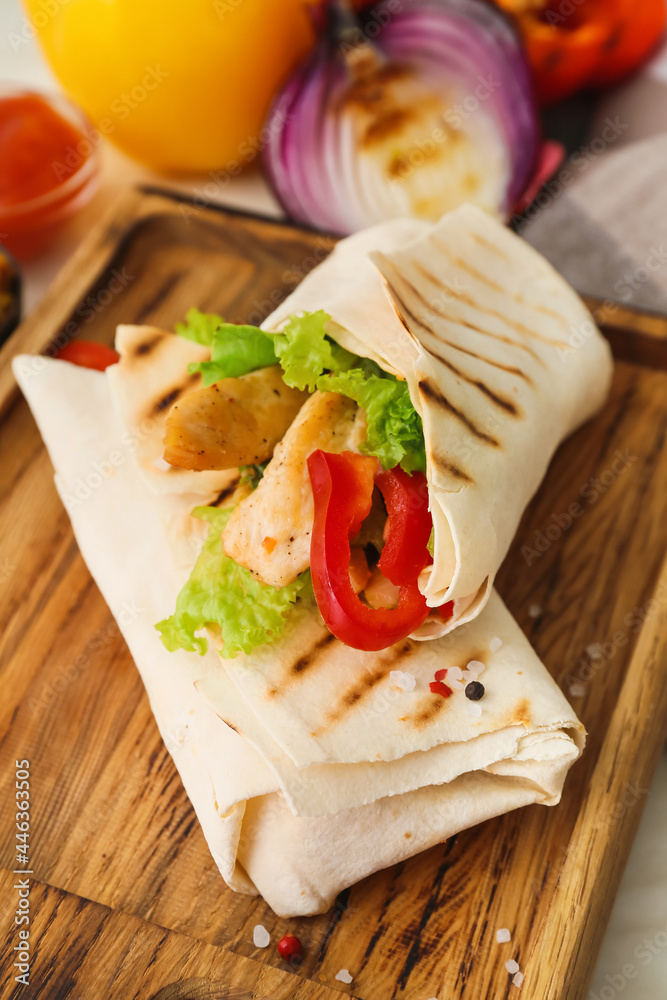 Board with tasty doner kebab on light background, closeup