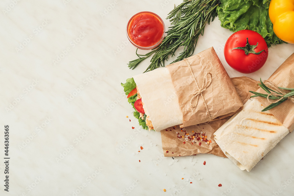 Tasty doner kebabs and sauce on light background