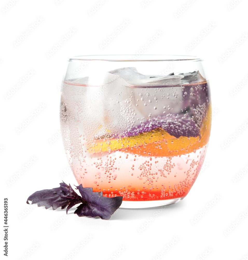 Glass of tasty lemonade with basil on white background