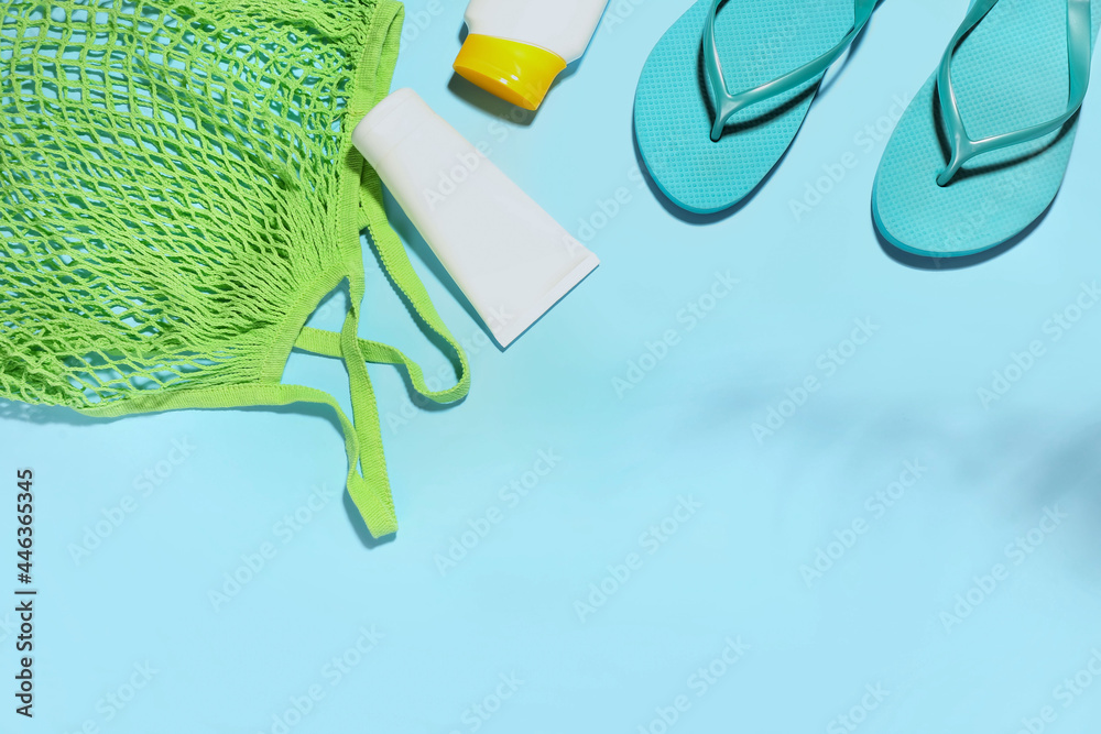 Set of beach accessories and cosmetics on color background