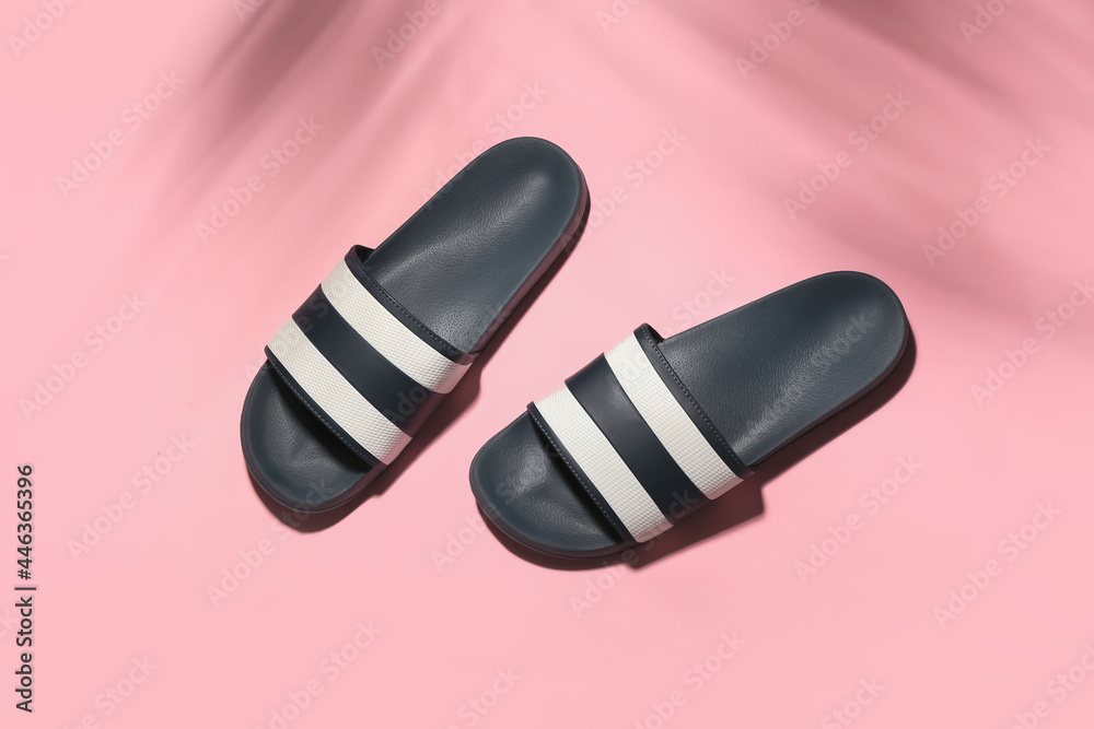 Stylish flip-flops on color background