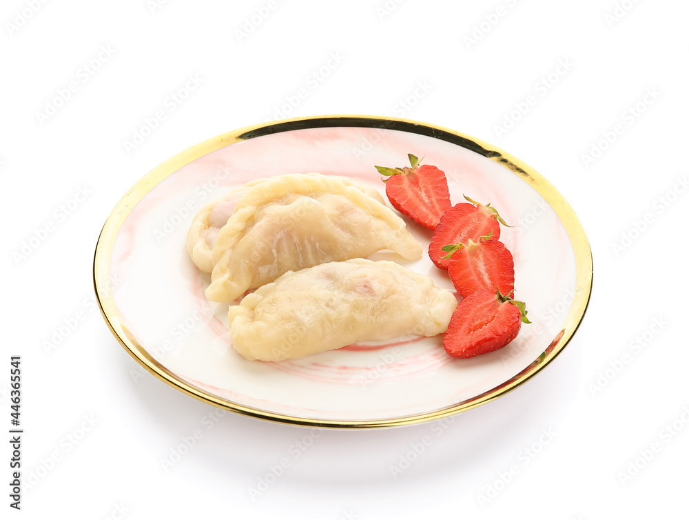 Plate with tasty dumplings and strawberry on white background