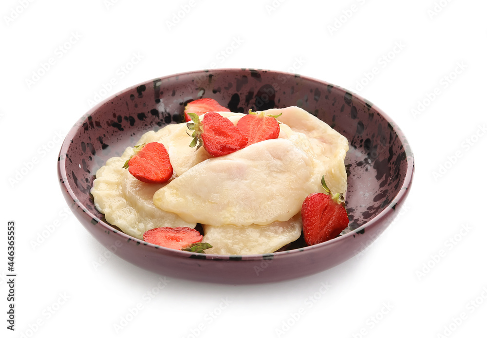 Plate with tasty dumplings and strawberry on white background