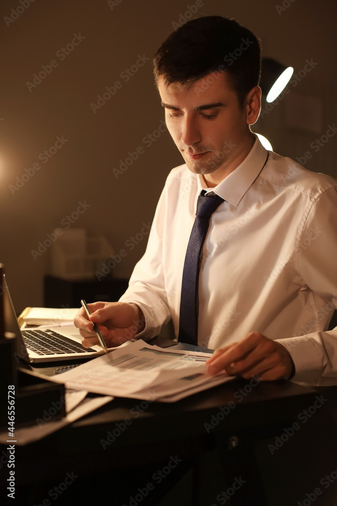 Businessman working in office late at night