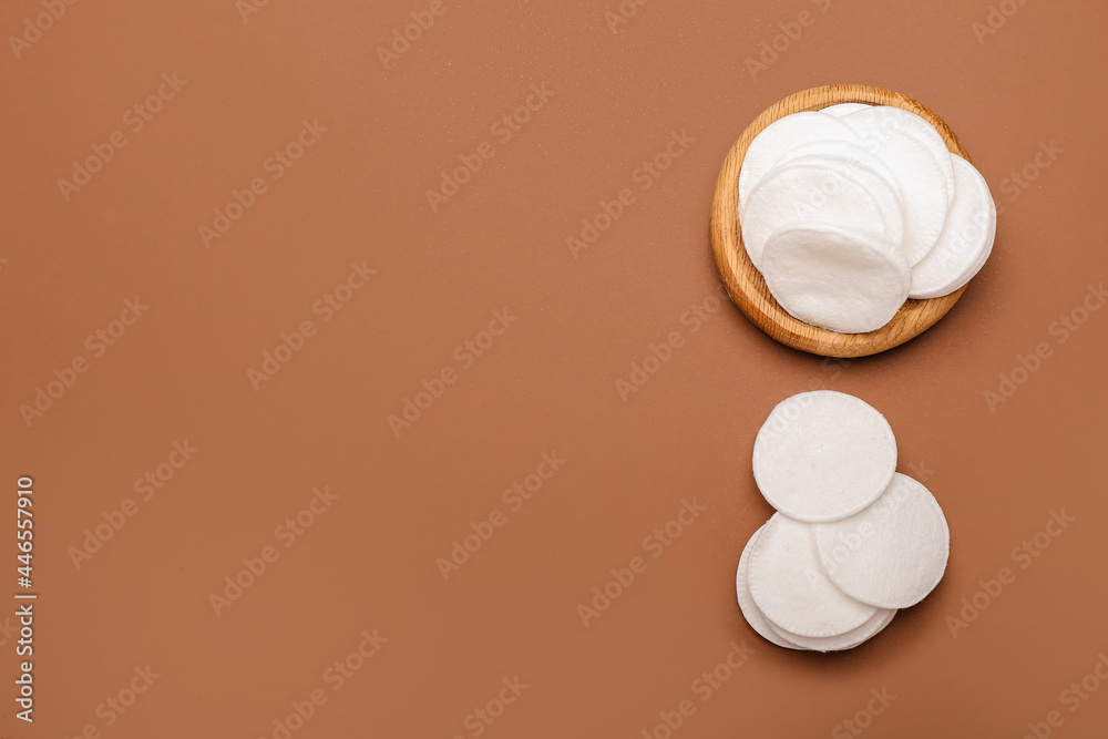 Holder with cotton pads on color background